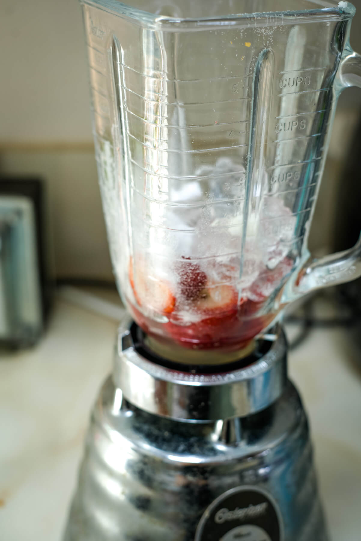 ice and strawberries in a blender