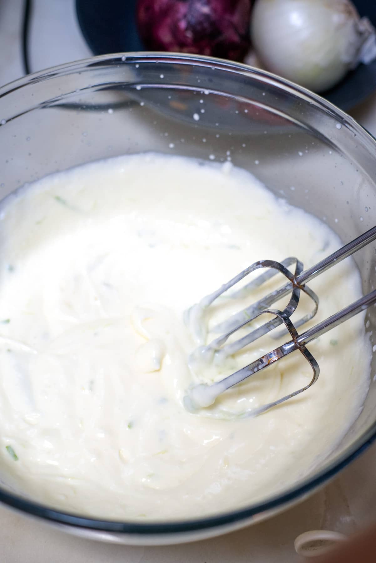whisking cream in a bowl