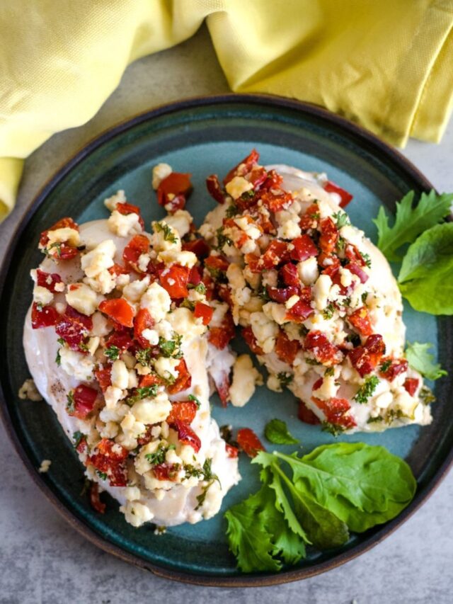 chicken breasts with chopped red pepper and feta cheese on a plate