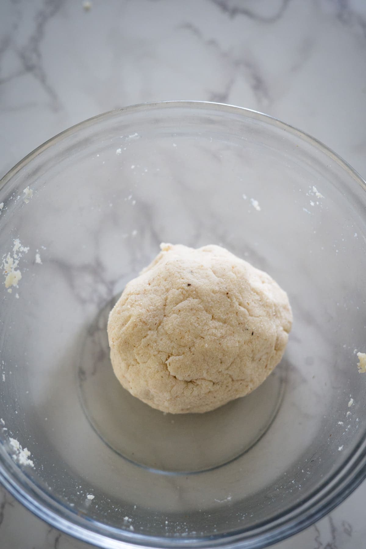 A ball of coconut flour dough in a glass bowl.
