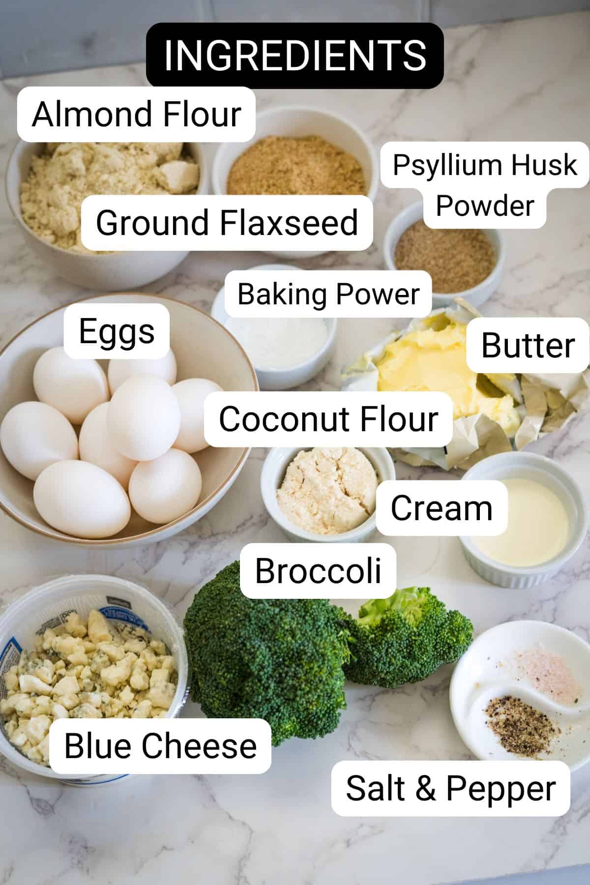 A collection of ingredients for a broccoli and blue cheese quiche, including almond flour, ground flaxseed, psyllium husk powder, eggs, baking powder, coconut flour, butter, cream, broccoli, blue cheese, salt, and pepper.