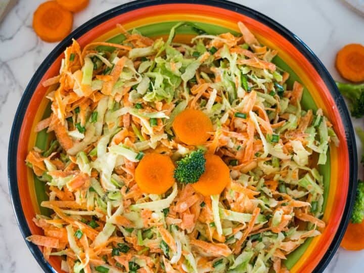 Carrot slaw in a bowl with carrots and broccoli coleslaw.