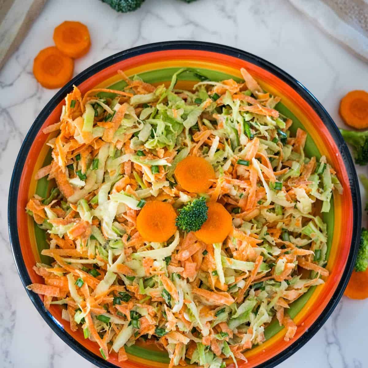 Carrot slaw in a bowl with broccoli stem slaw.