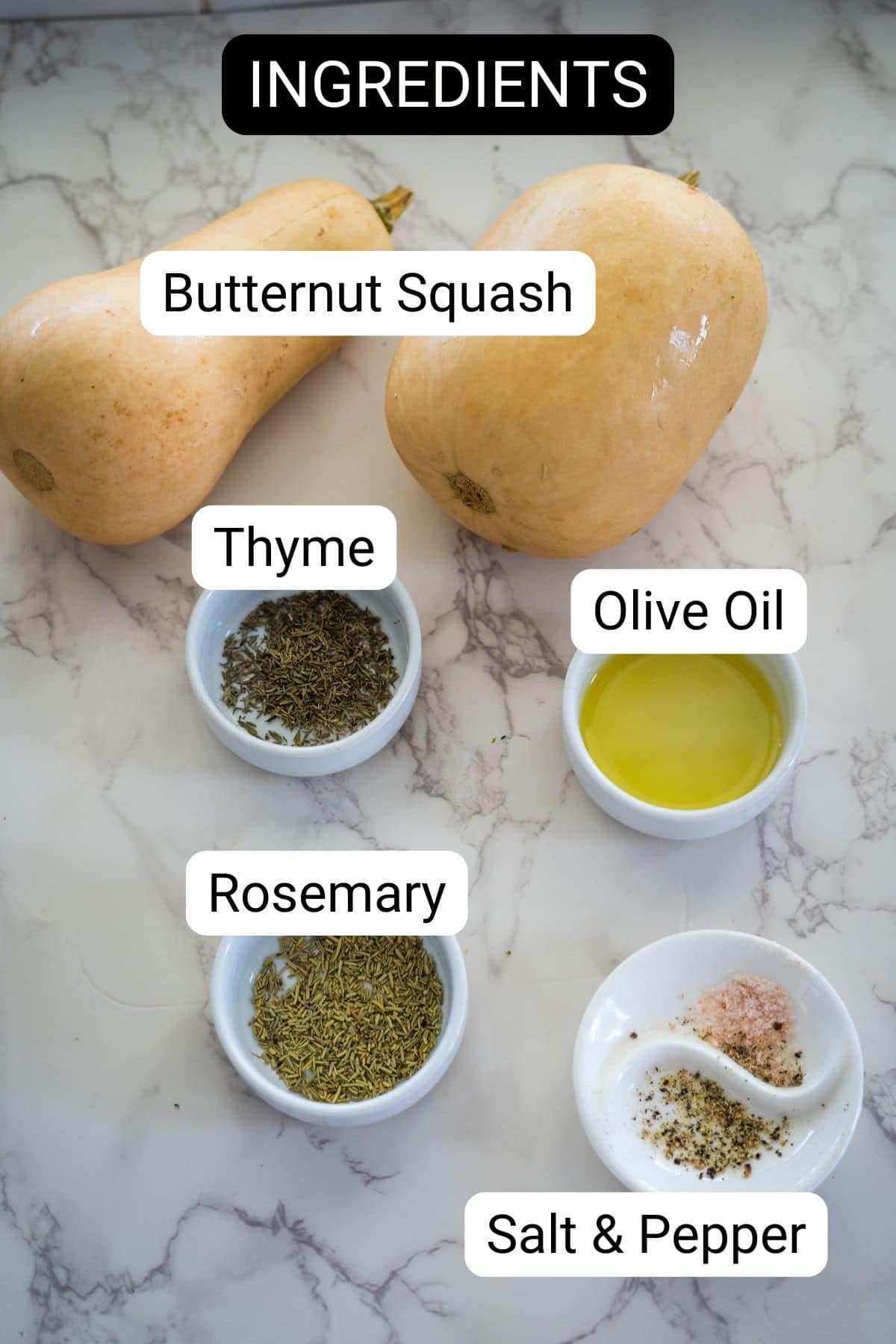 Ingredients for a recipe including butternut squash fries, thyme, rosemary, olive oil, salt, and pepper are displayed on a marble surface.