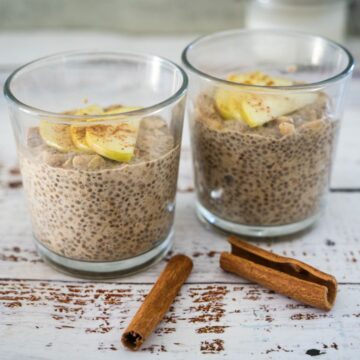 Two glasses of chia pudding with cinnamon and apples.