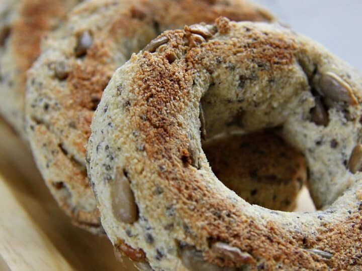 Close-up of sunflower chia seed bagels on a wooden board.