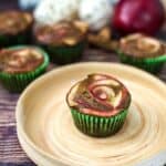 Apple cinnamon cupcakes arranged beautifully on a rustic wooden plate.