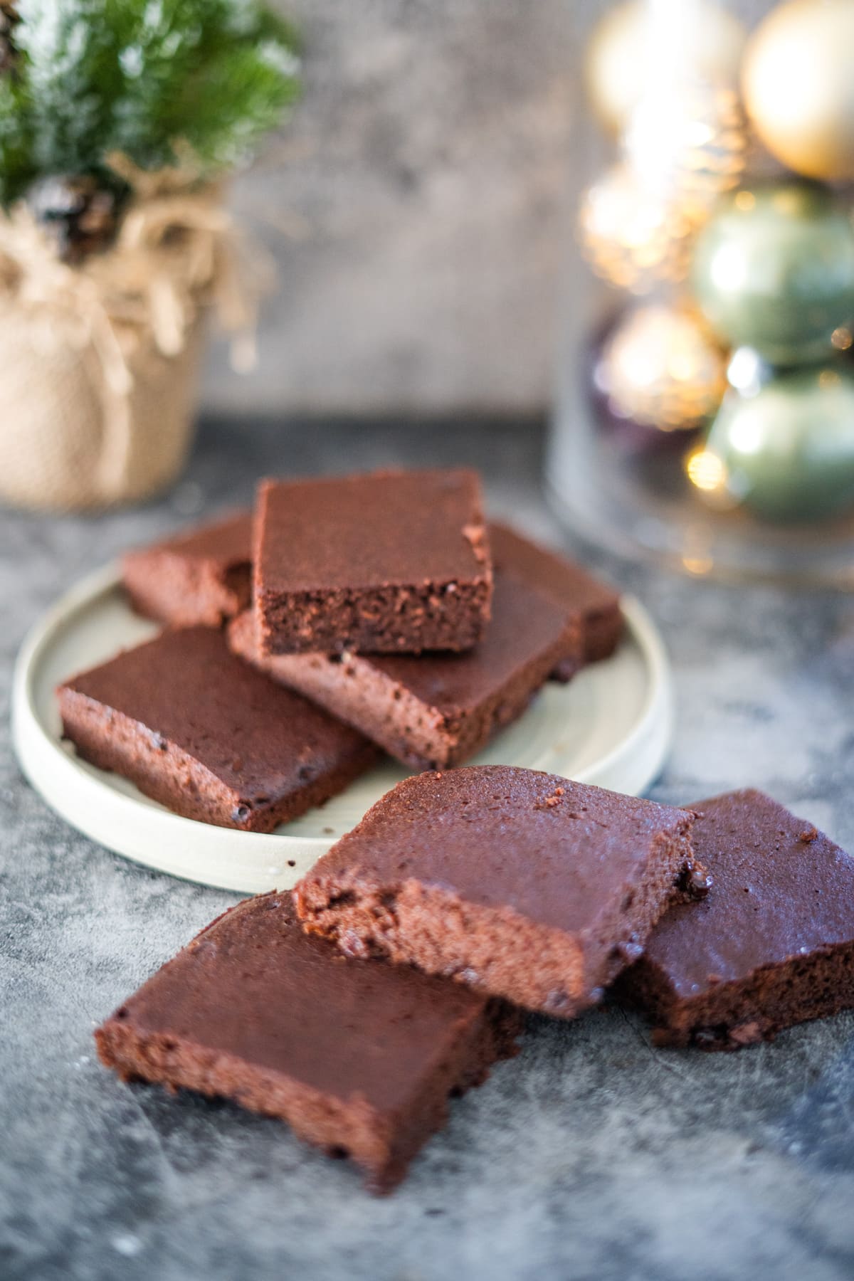         Description: Spiced brownies on a plate with christmas decorations.