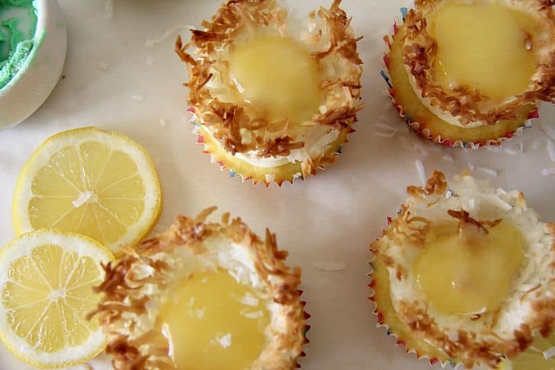 Homemade lemon coconut tarts displayed with lemon coconut slices.