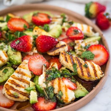 grilled halloumi slices with strawberries on a plate