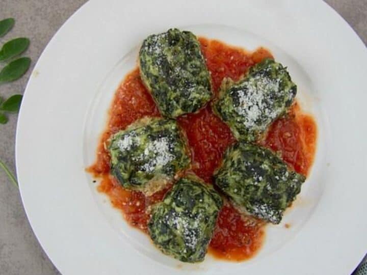 Stuffed spinach ricotta gnocchi on a white plate.