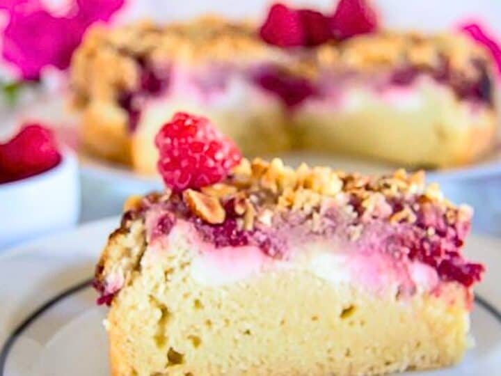A slice of raspberry almond coffee cake on a plate.
