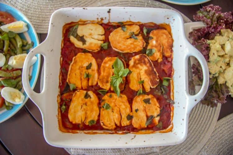 slices of halloumi baked in a tomato sauce
