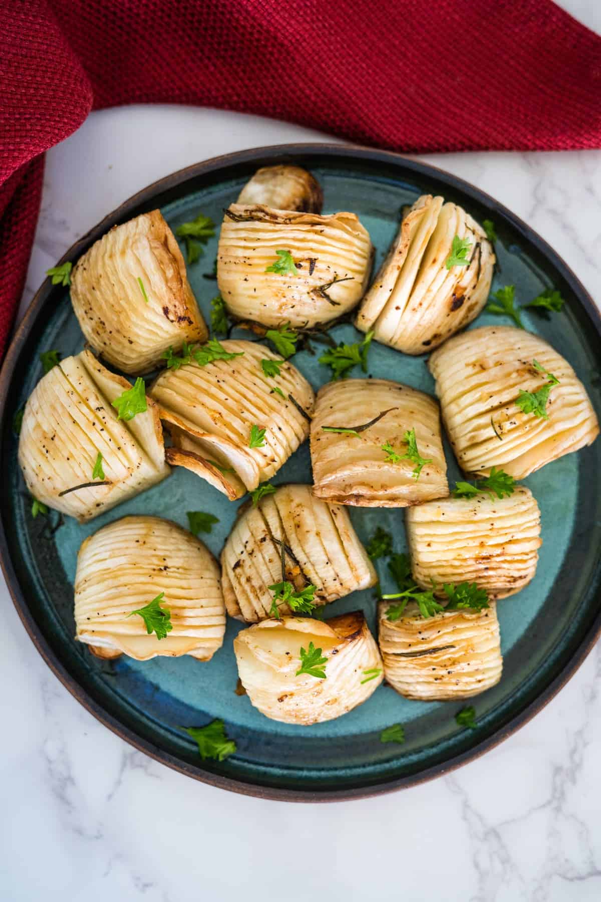 Roasted artichokes on a plate with parsley, perfect for a keto-friendly meal.