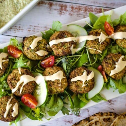 A plate of keto falafel with tzatziki sauce and pita bread.