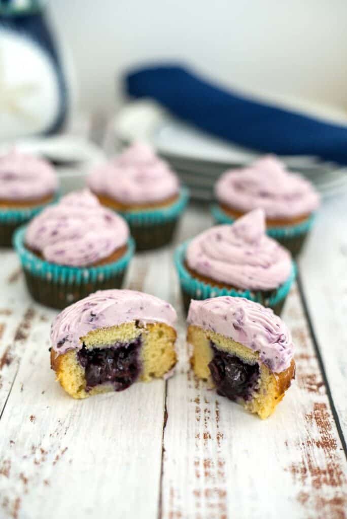 vanilla cupcakes with blueberry filling and frosting