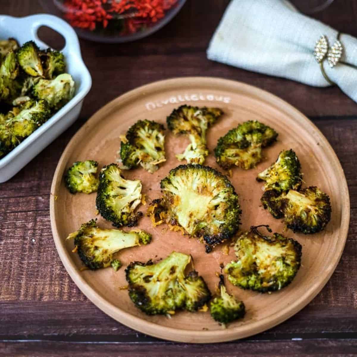 Keto roasted broccoli on a wooden plate.