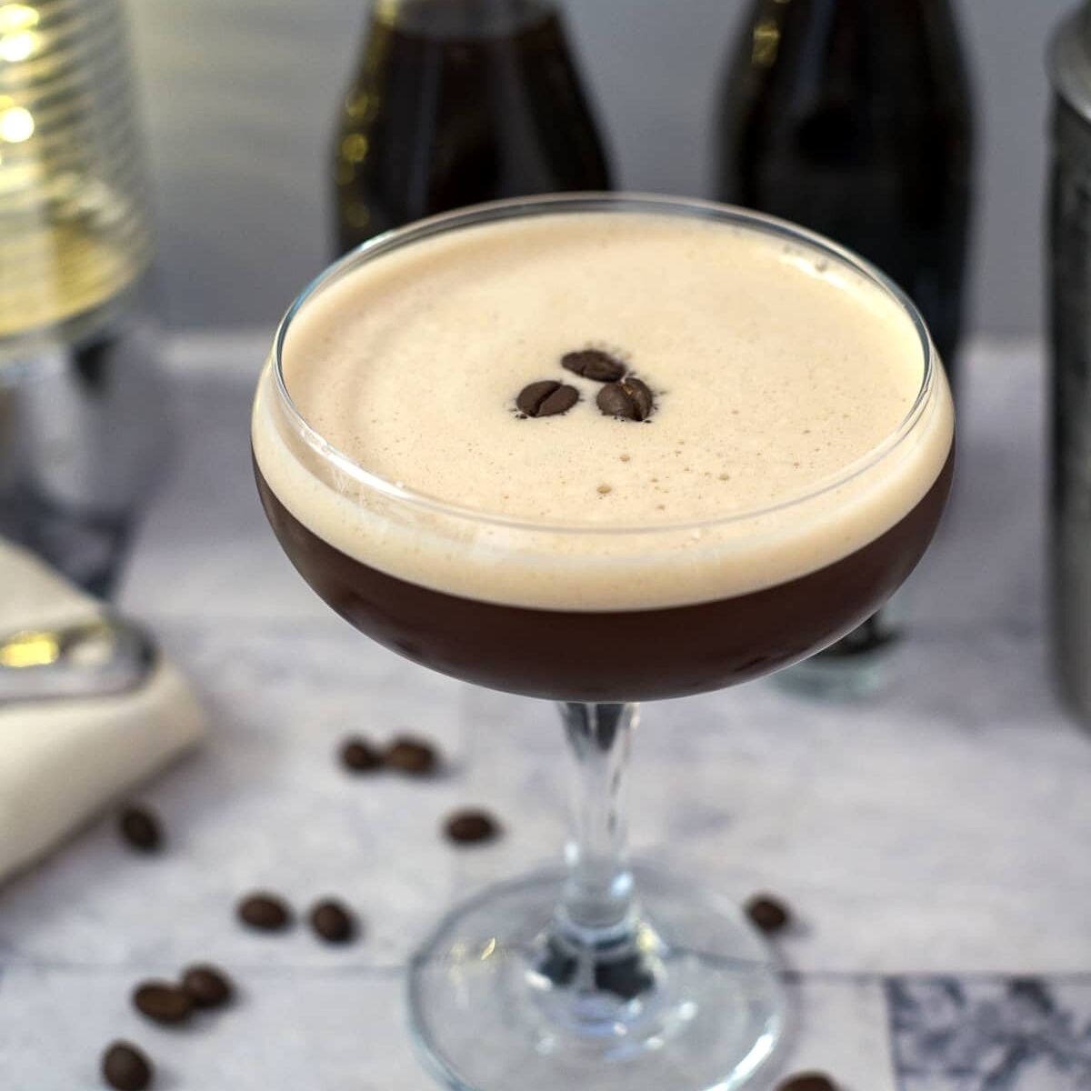 A keto espresso martini garnished with coffee beans in the glass.