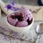 lavender ice cream in bowl with berries