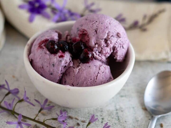 lavender ice cream in bowl with berries