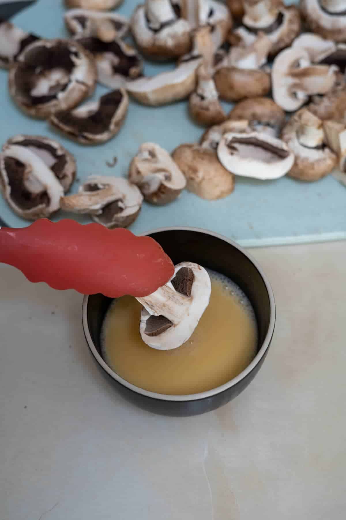 dipping mushrooms in egg