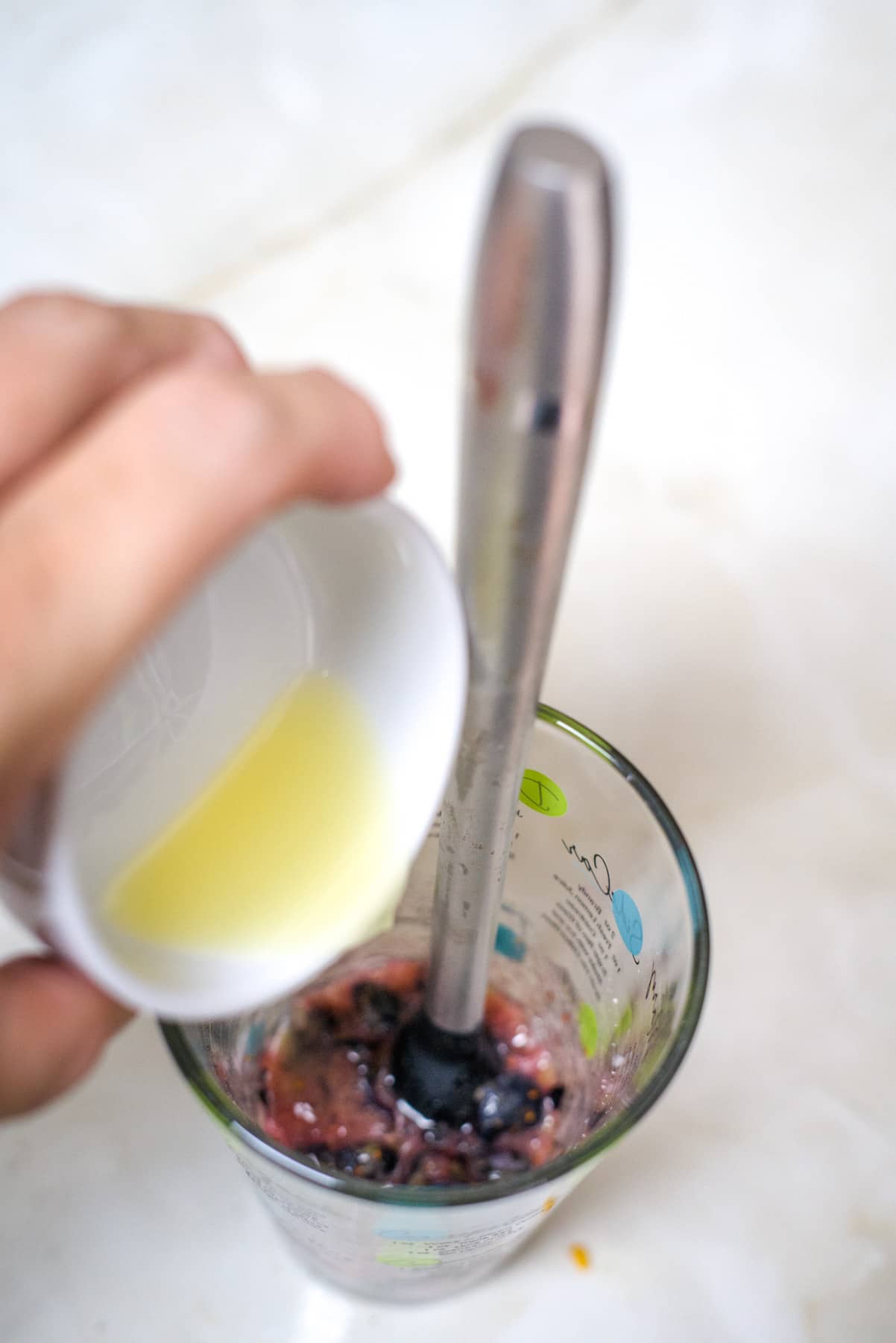 lime juice added to glass of muddled blueberries