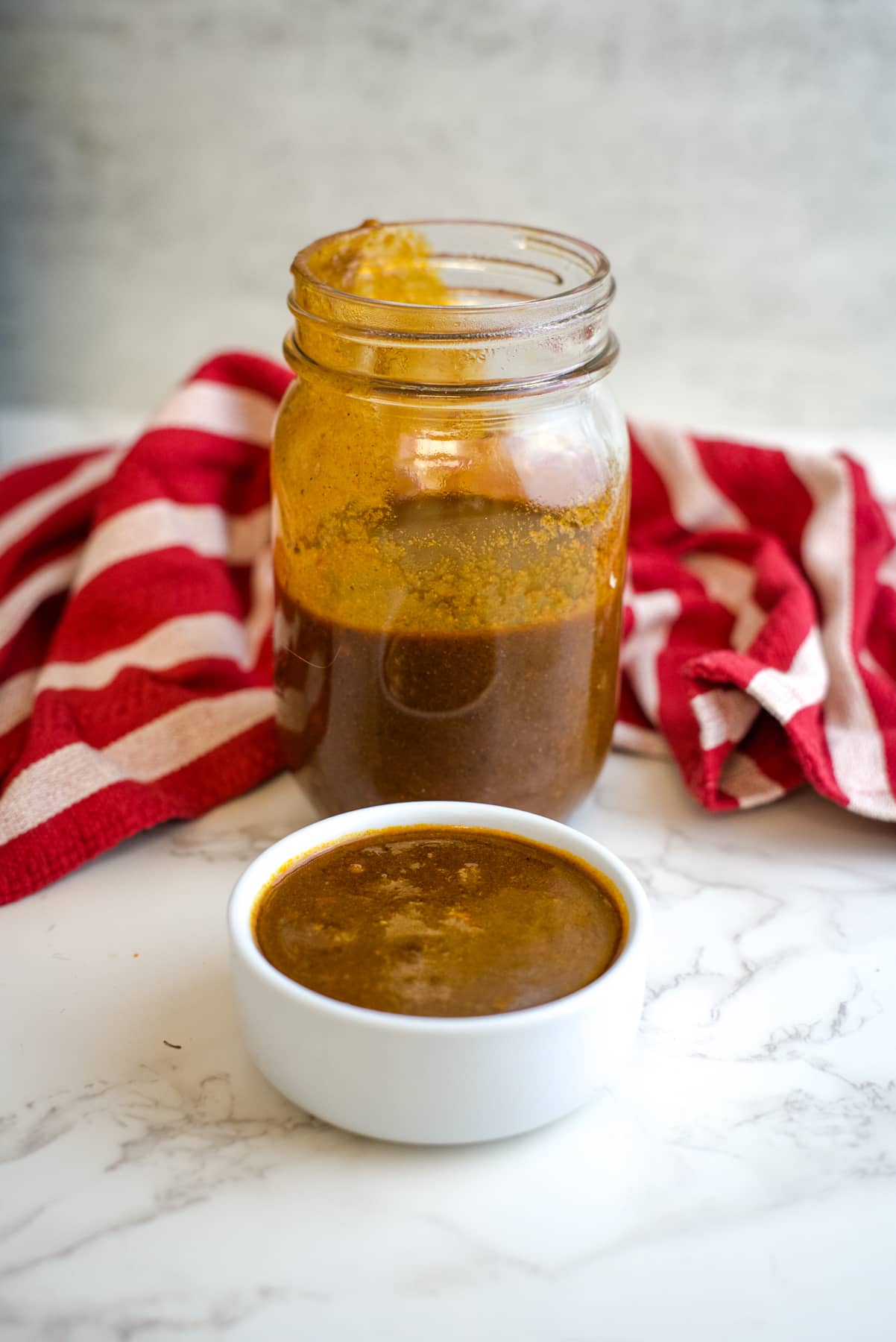 low carb enchilada sauce in a glass and serving dish