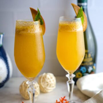 two tall glasses of peach bellini