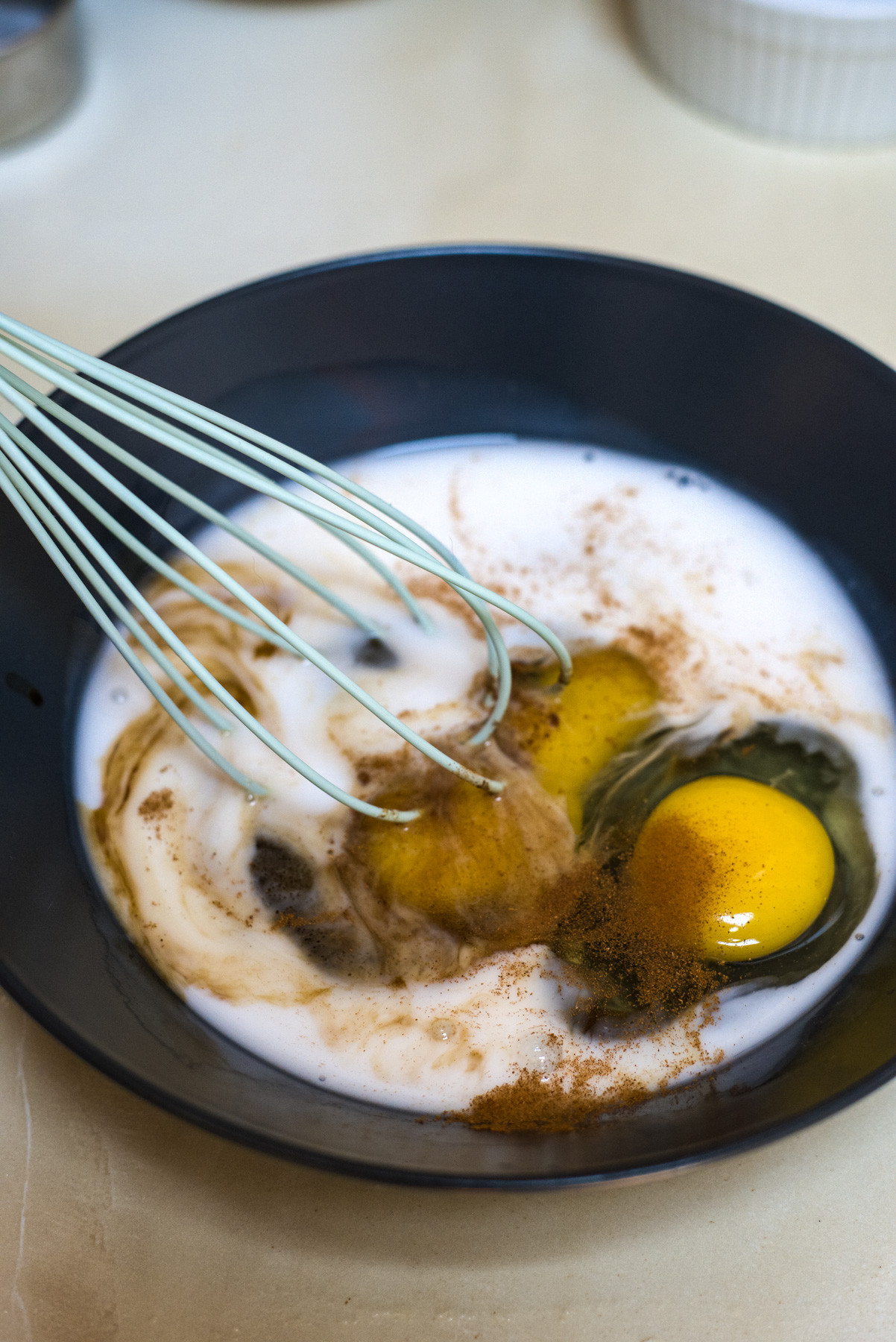 whisking egg and almond milk with cinnamon