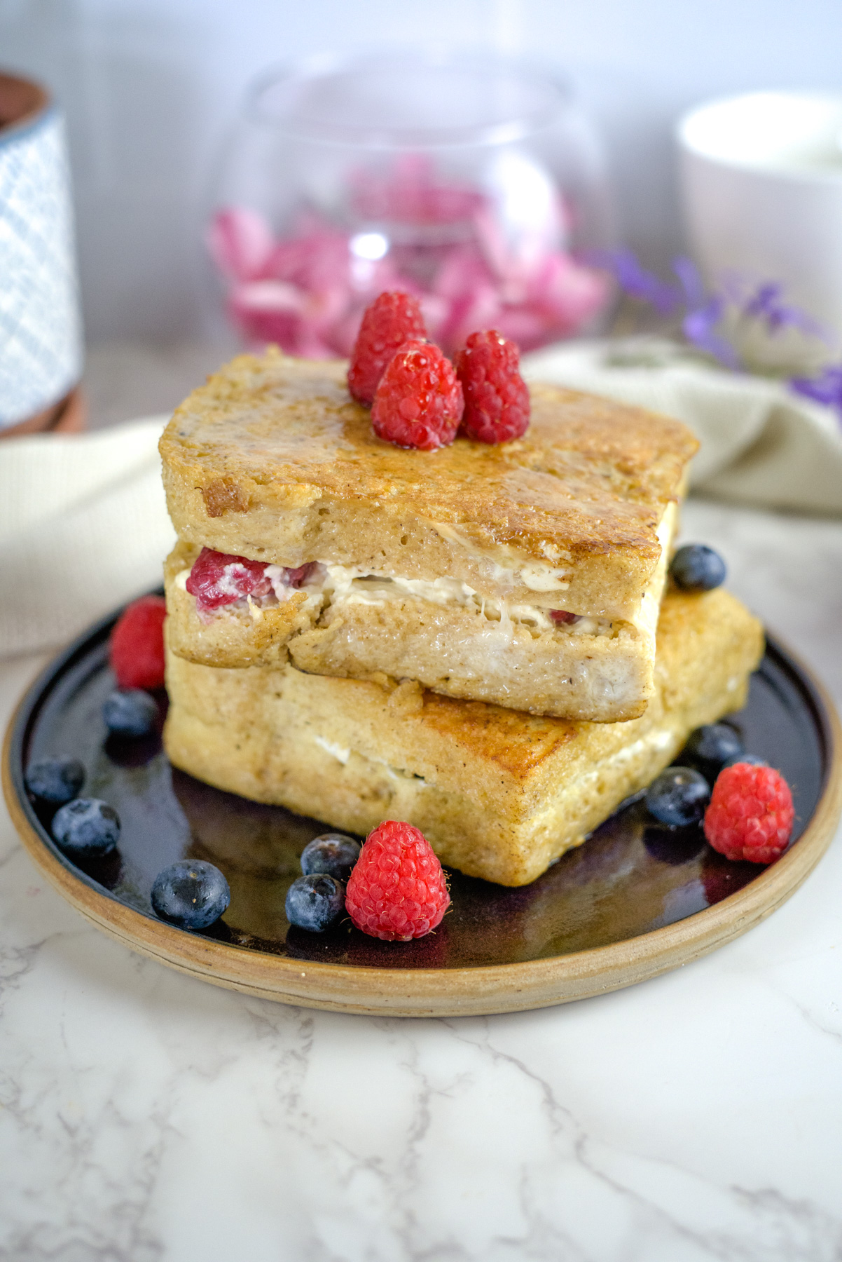 stuffed french toast on a plate with berries