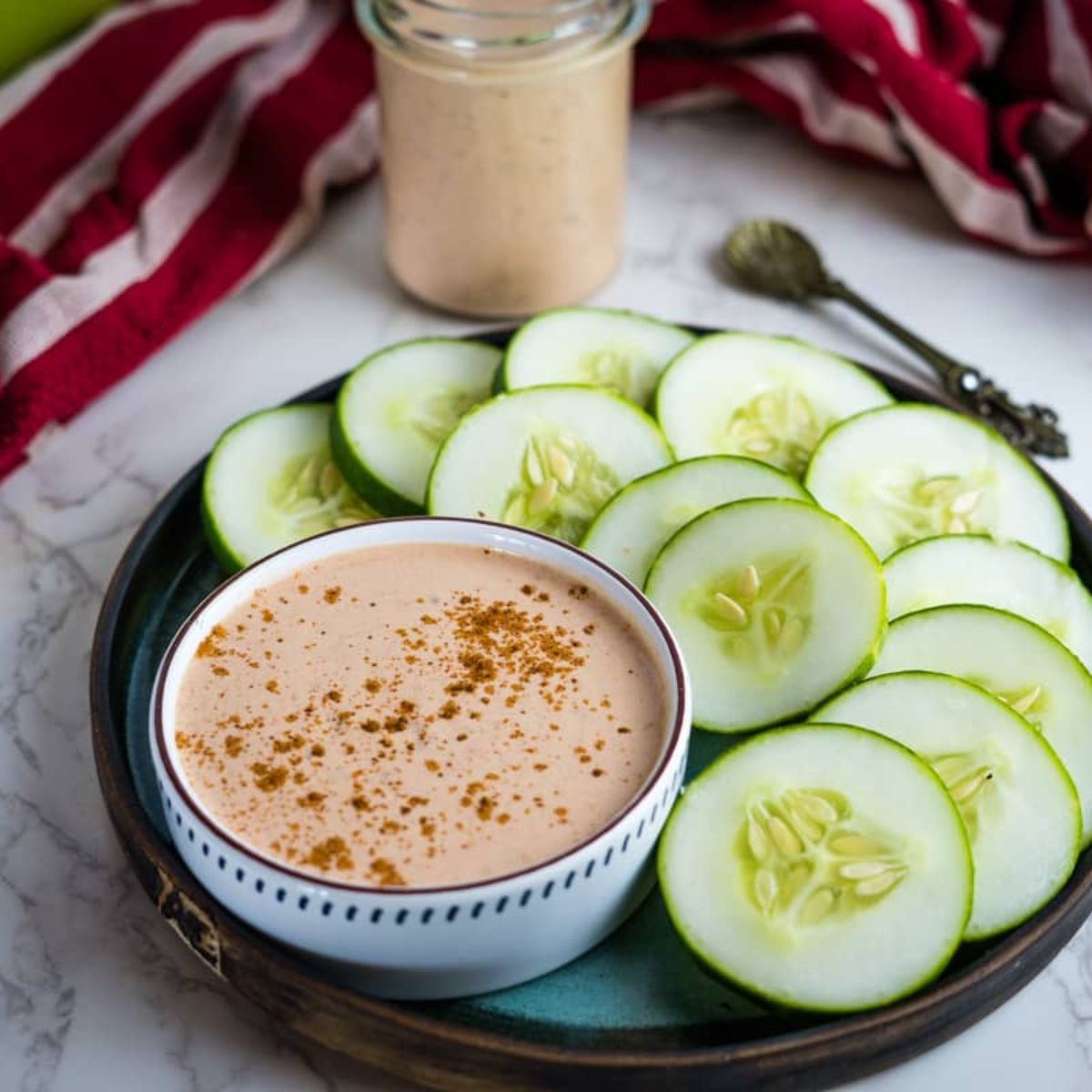 keto cocktail sauce with sliced cucumbers.
