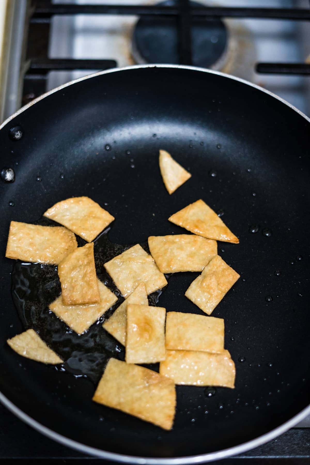 fried flat bread pieces in a pan.