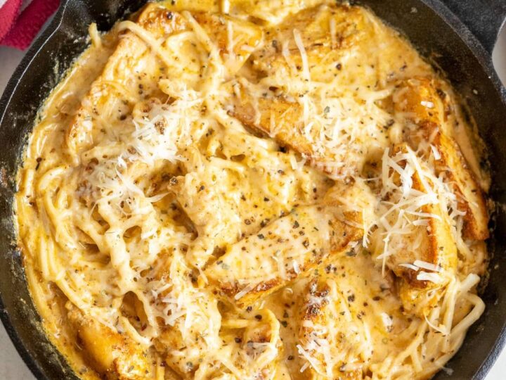 A skillet filled with chicken and pasta.