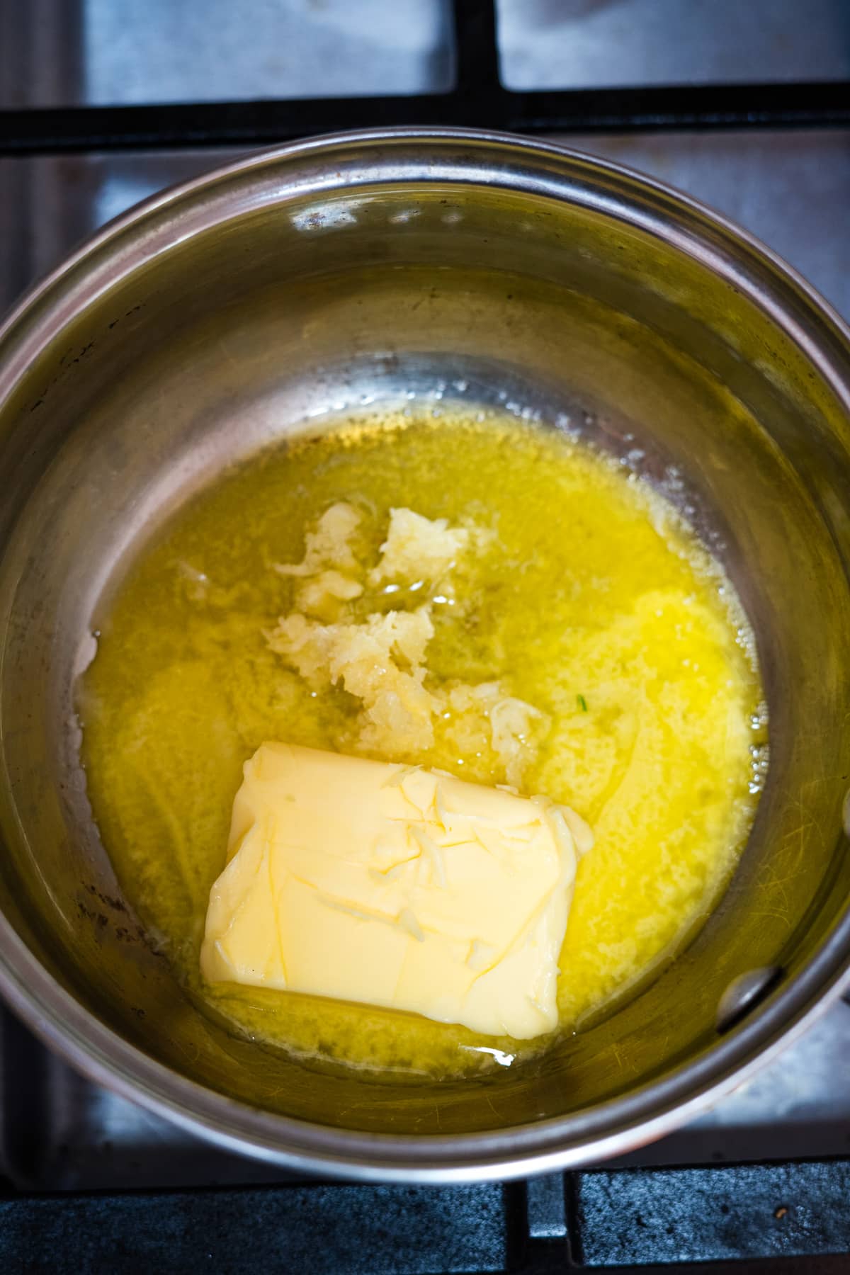 butter in a pan on a stove top.