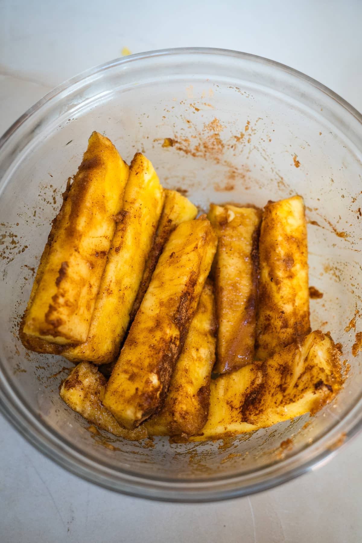 A bowl with pieces of fried bananas in it.