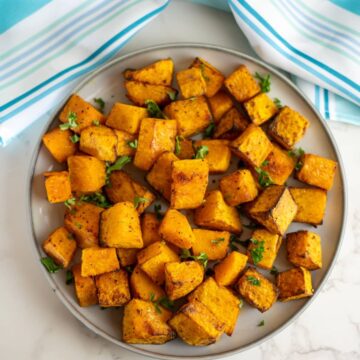 Roasted sweet potato cubes on a plate.