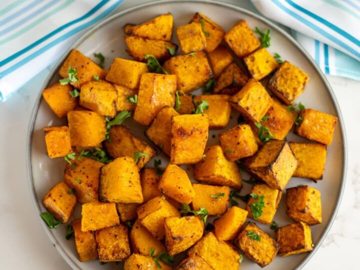 Roasted sweet potato cubes on a plate.