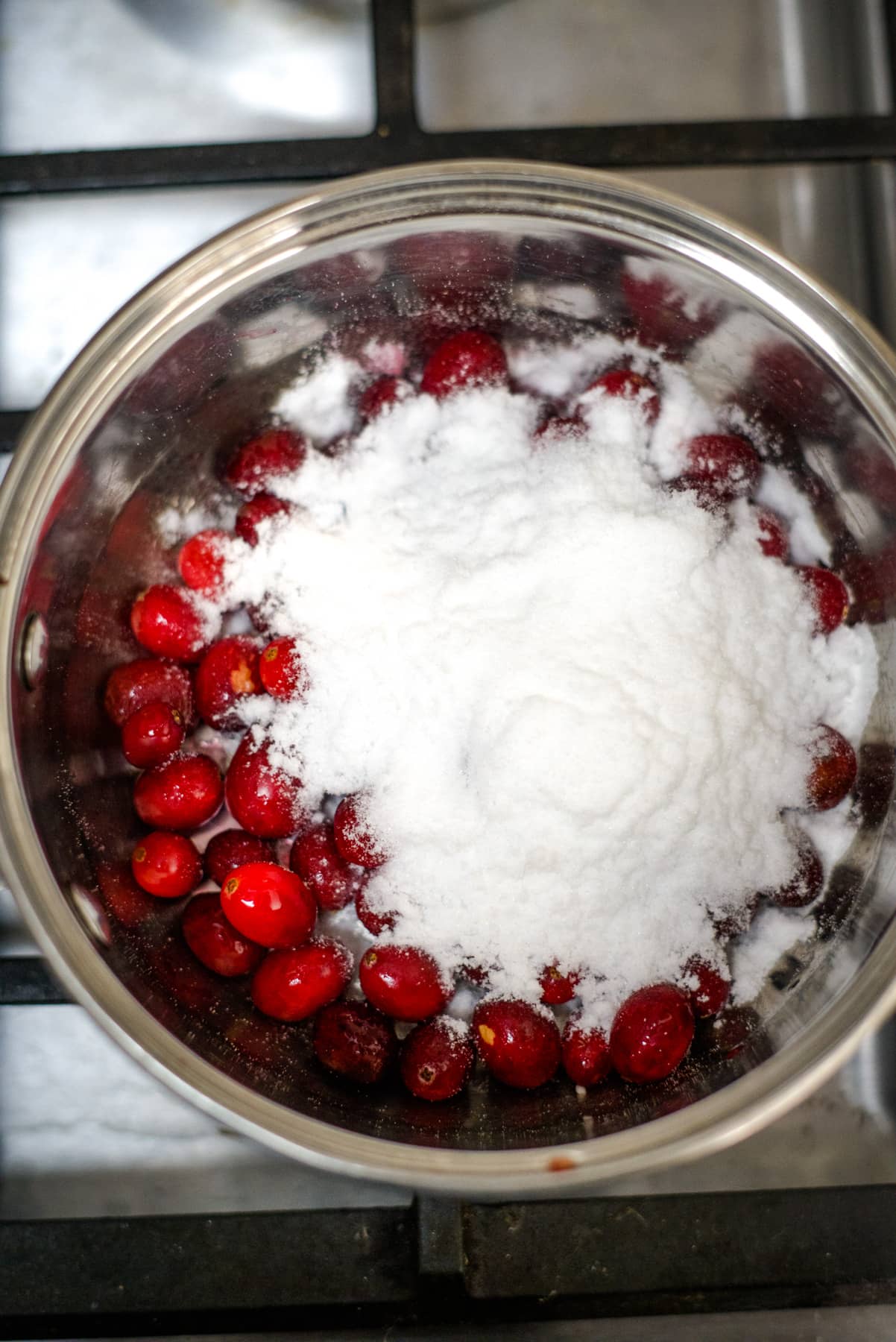 Cranberries in a bowl on top of the stove.