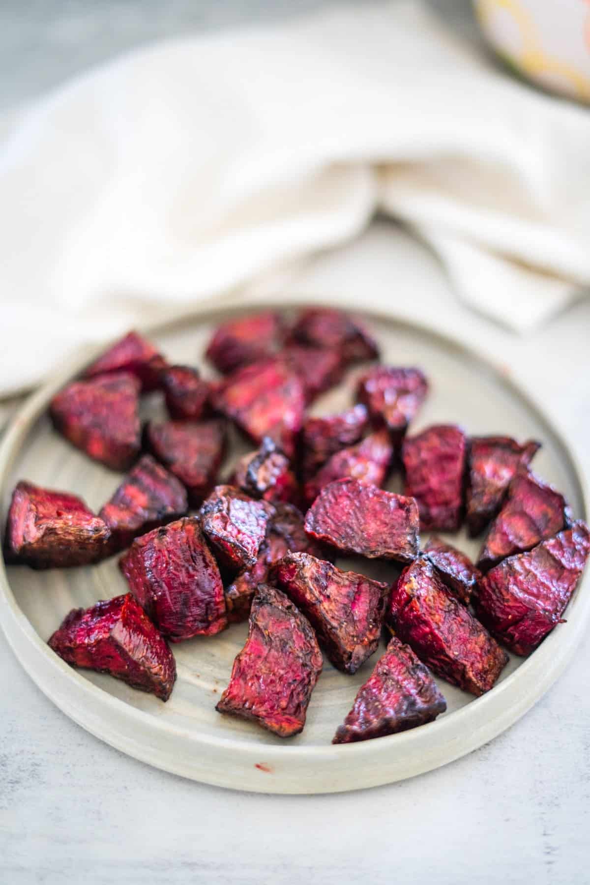 Roasted beets on a plate with a napkin.