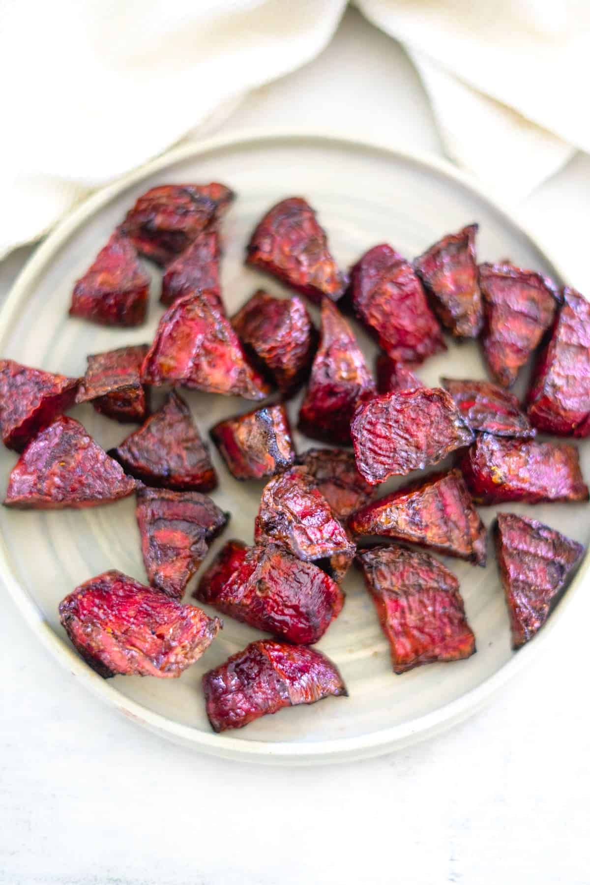 Air fryer roasted beets on a plate with a napkin.