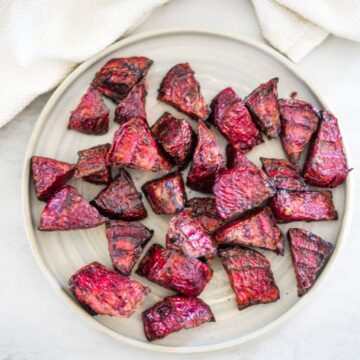 Grilled beets on a white plate.