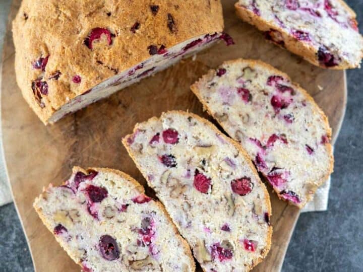 Cranberry walnut bread on a cutting board.