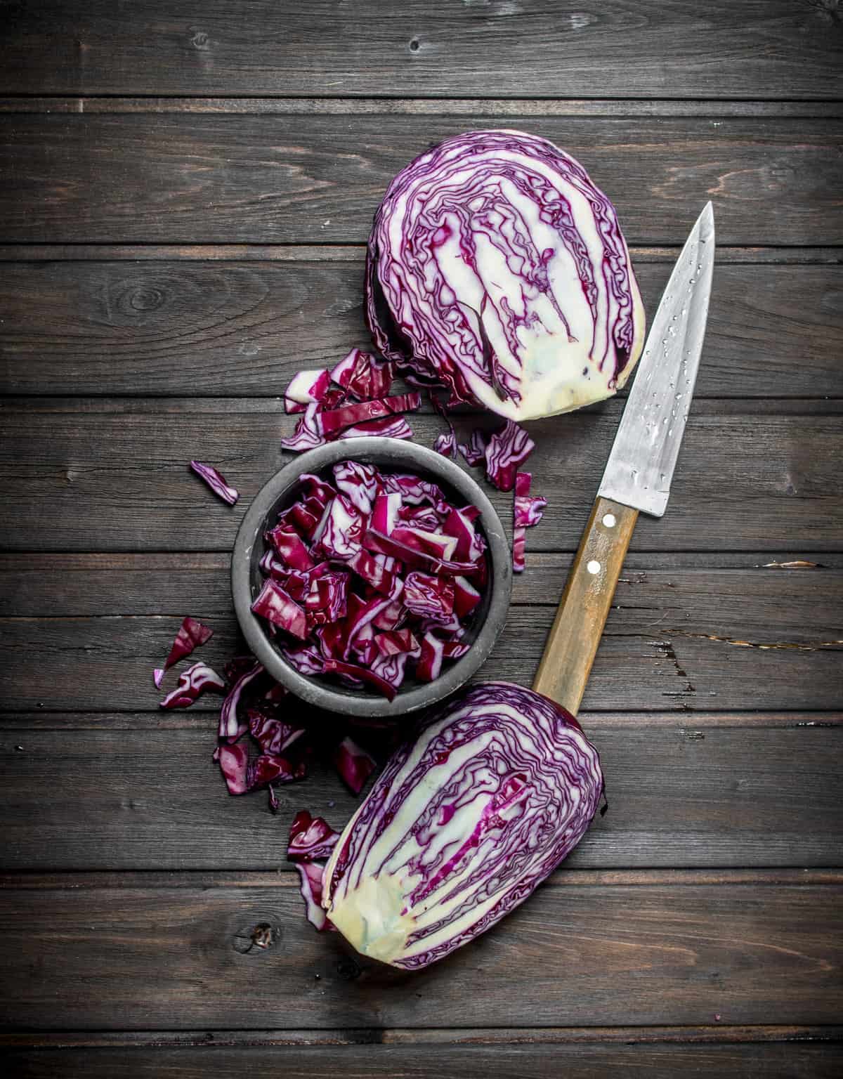 Roasted red cabbage in a bowl on a wooden table.