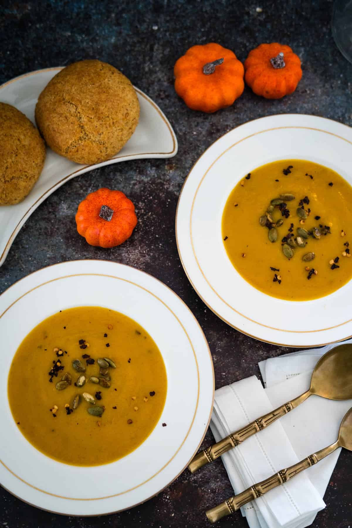 Two bowls of pumpkin soup.