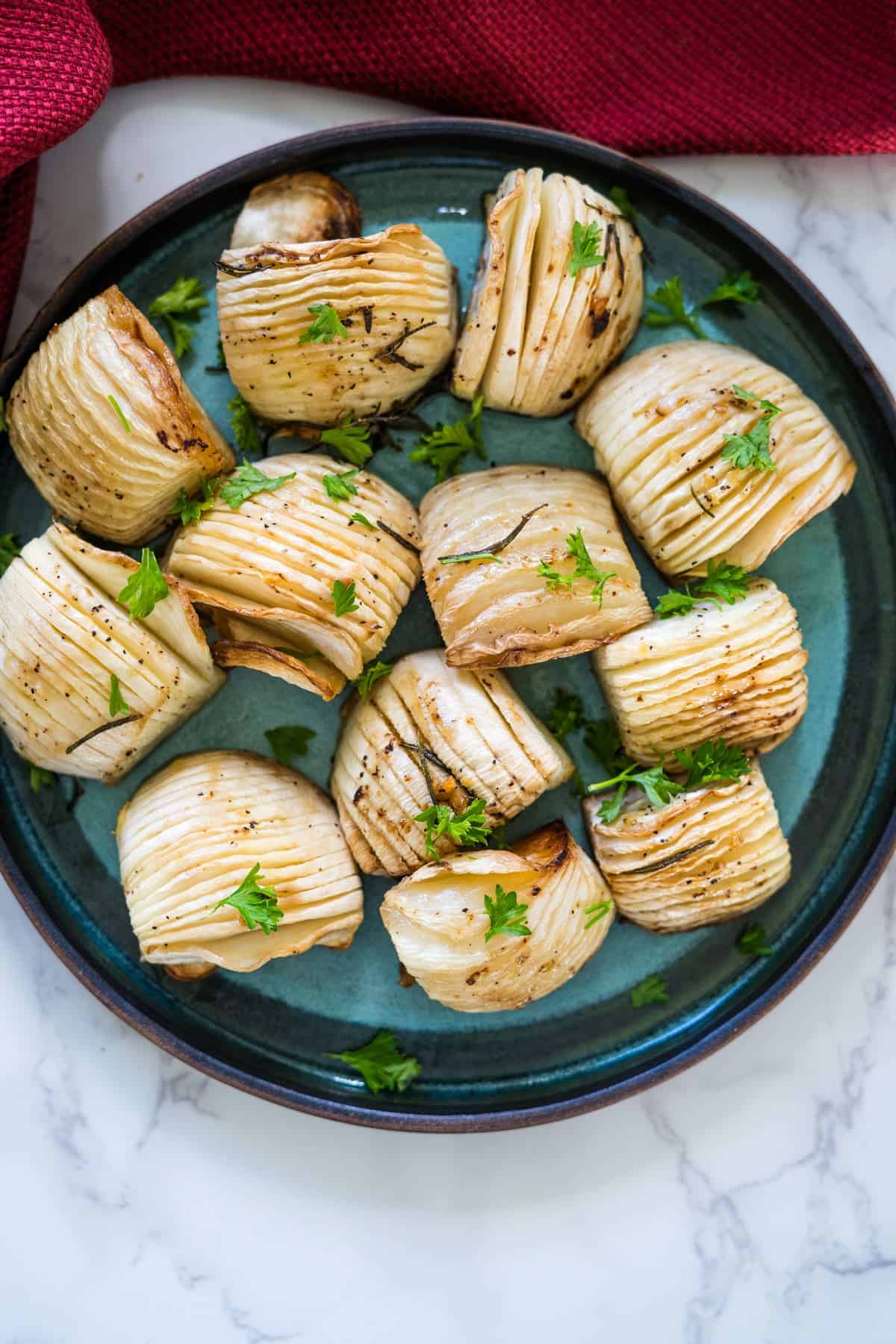 Roasted artichokes on a plate with parsley, perfect for a keto-friendly side dish.