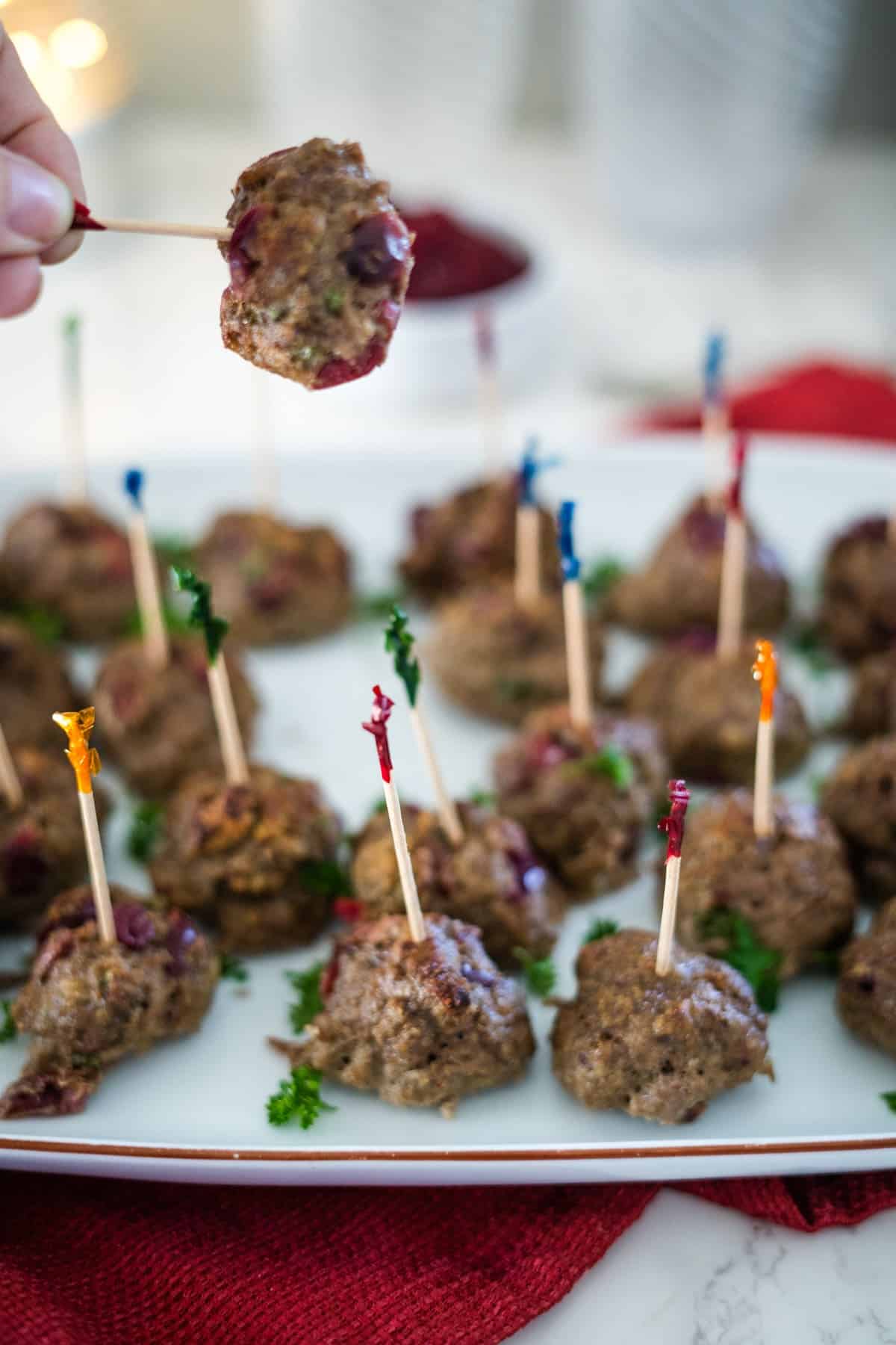 Keto cranberry turkey meatballs on a plate with toothpicks.