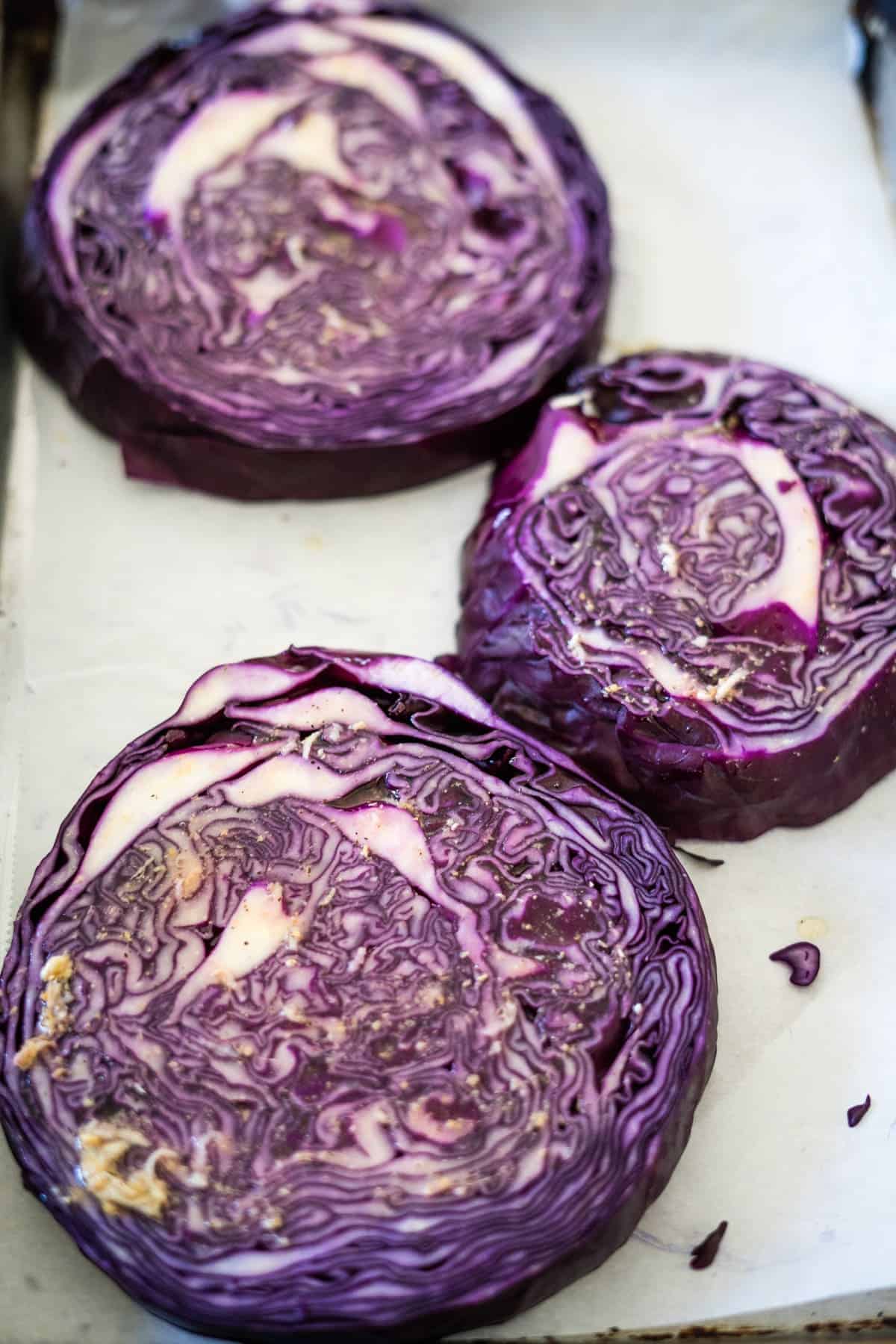 Roasted purple cabbage on a baking sheet.