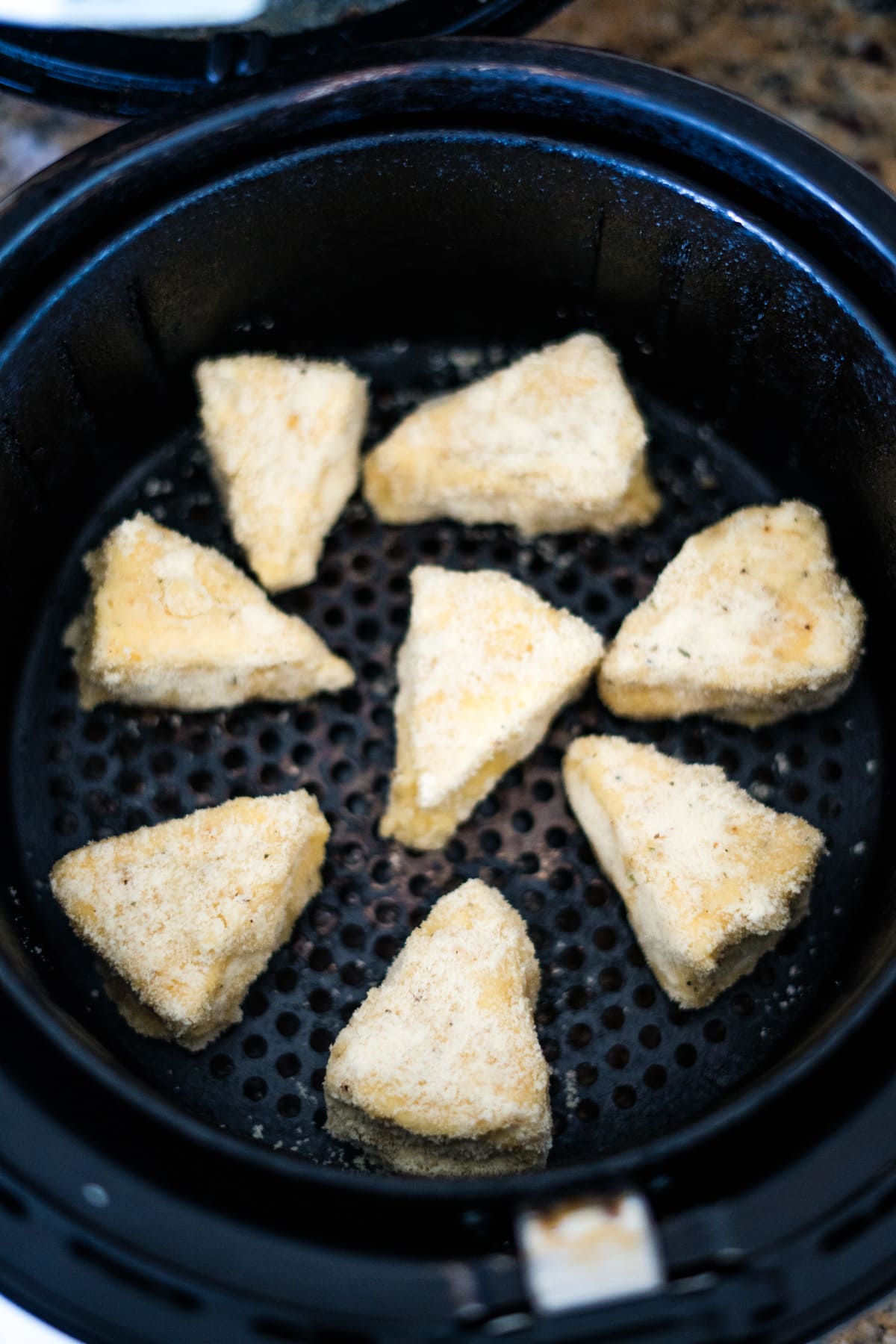 A group of biscuits in an air fryer.