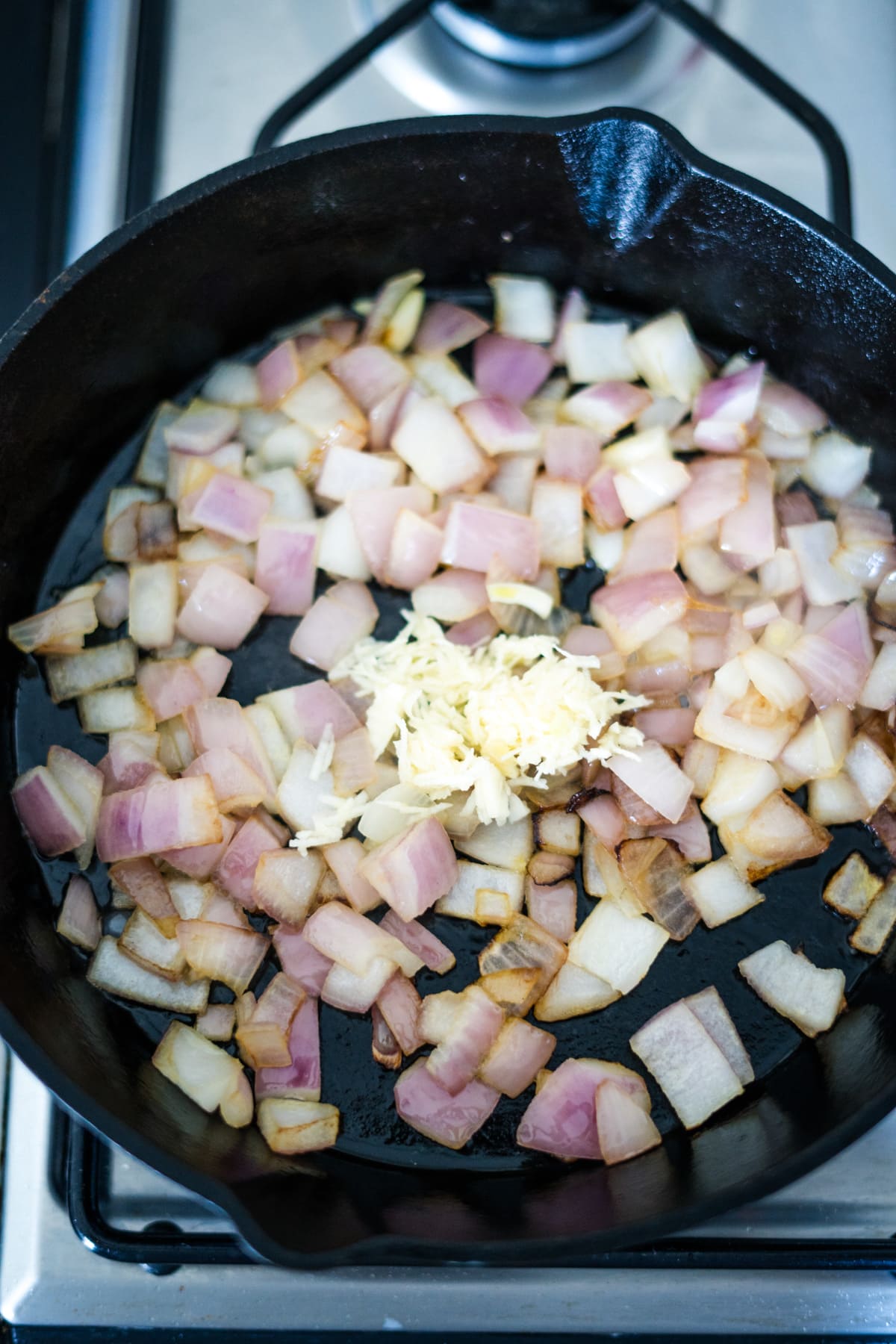 A vegetable wellington cooking in a frying pan.