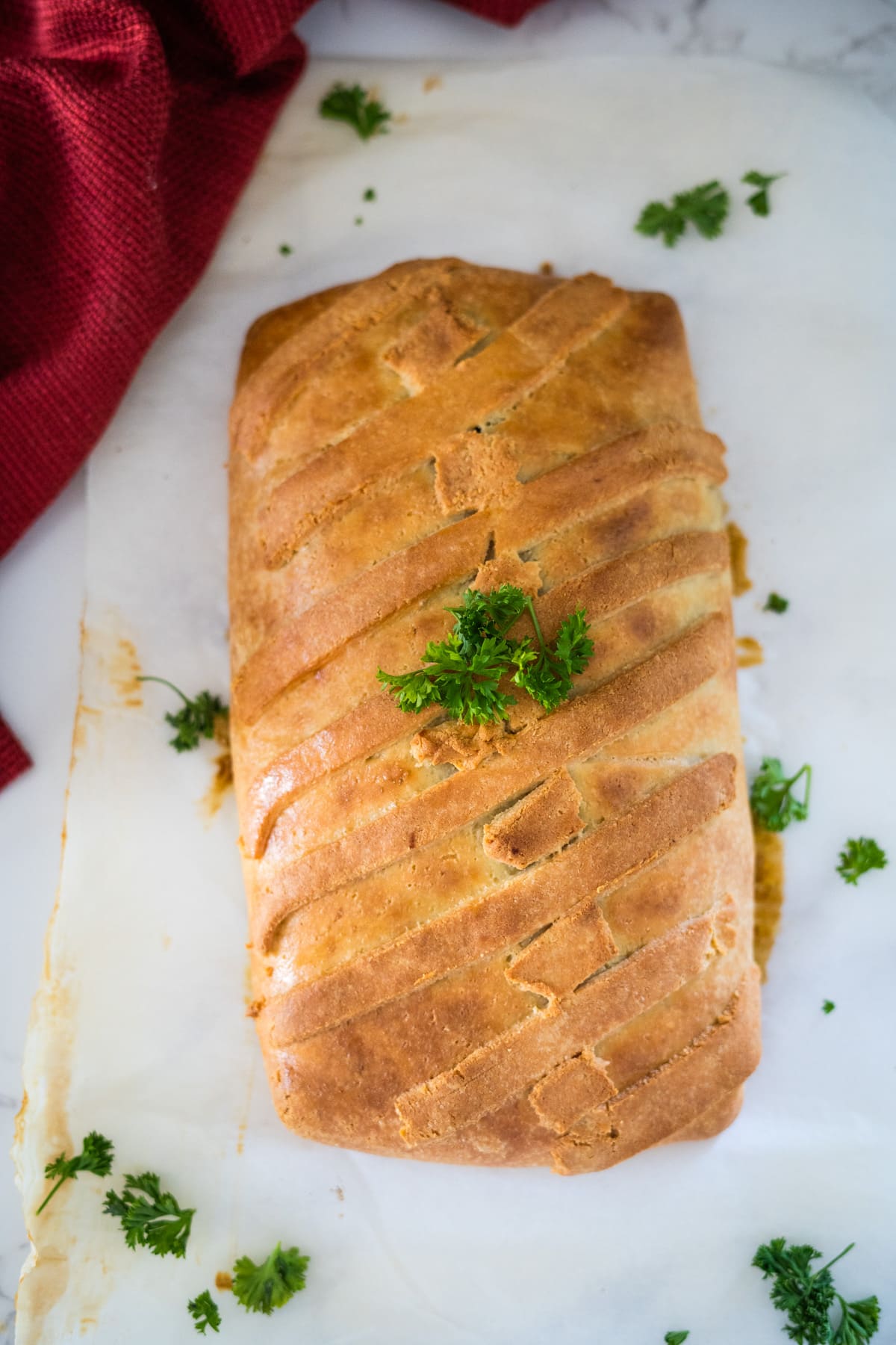 A flavorful vegetable wellington topped with parsley.